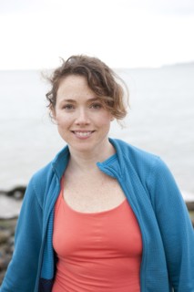 Caucasian woman smiling on rocky beach