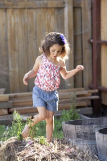 Mixed race girl playing in backyard