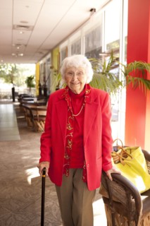 Older Caucasian walking with cane in retirement home