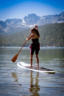 Mixed race woman on paddle board in Lake Tahoe