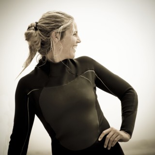 Smiling Caucasian woman wearing wetsuit