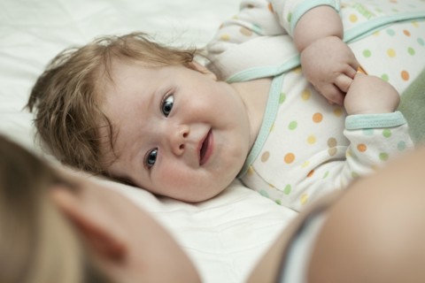 Caucasian mother and daughter laying on bed