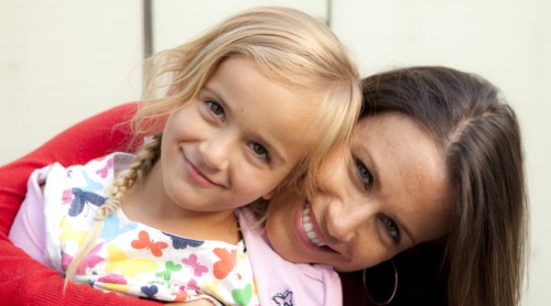 Caucasian mother and daughter smiling outdoors