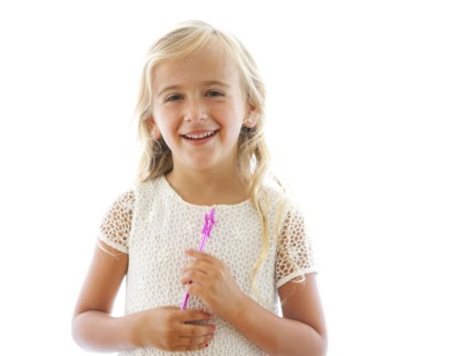 Smiling Caucasian girl holding fairy wand