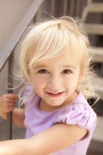 Smiling Caucasian girl sitting on steps