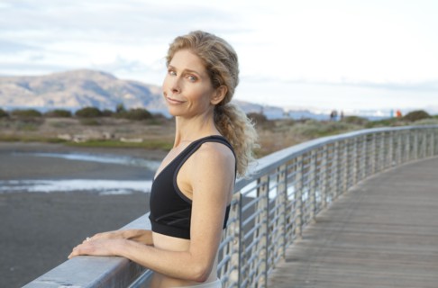Caucasian woman standing on footbridge