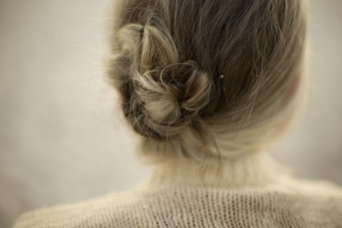Close up of woman wearing bun and sweater