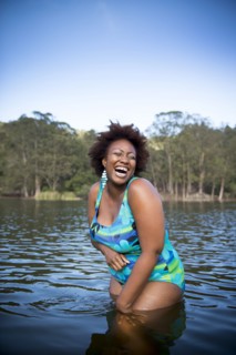 African American woman standing in rural lake