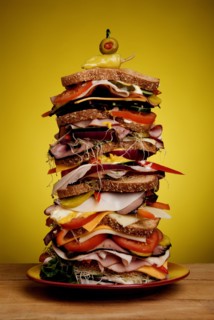 Oversized stacked deli sandwich on plate