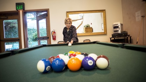 Older Caucasian woman playing pool