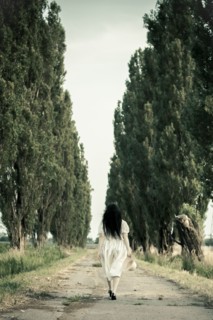 Woman walking on dirt road