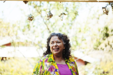 Hispanic woman smiling in backyard