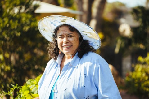 Hispanic woman smiling in backyard