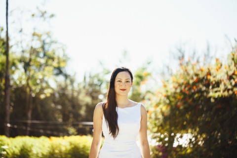 Korean bride smiling near trees