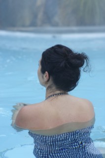 Rear view of woman swimming in pool