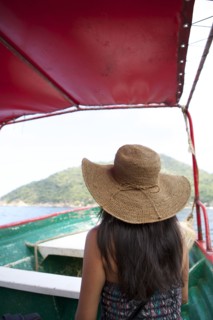 Woman wearing sun hat on ferry boat