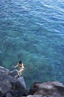 High angle view of woman climbing ladder out of ocean
