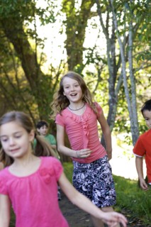 Children running on dirt path in park