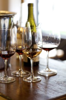 Glasses of red and white wine on table