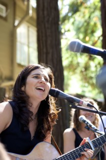 Musicians performing on stage outdoors