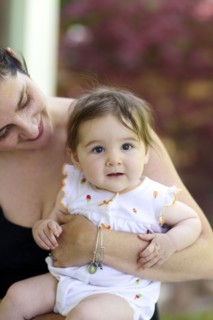 Close up of mother holding baby daughter