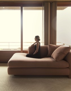 Woman sitting on sofa in modern living room