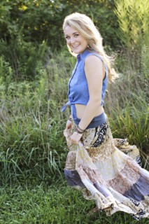 Teenage girl walking in tall grass