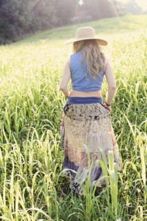 Teenage girl walking in tall grass