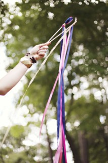 Low angle view of girl playing with ribbons outdoors