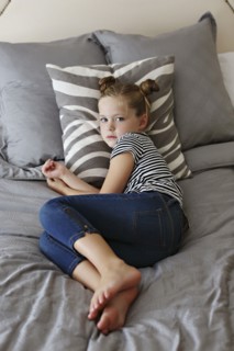 High angle view of girl laying on bed
