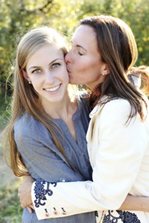 Close up of mother kissing cheek of daughter
