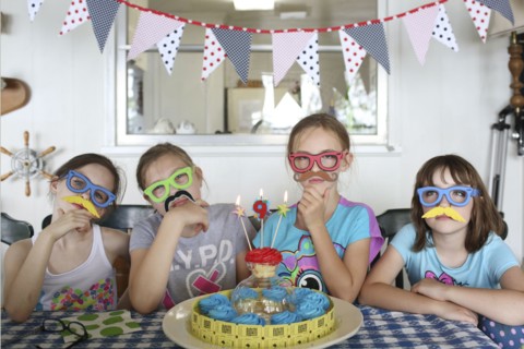 Children wearing disguises at birthday party