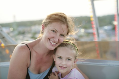 Mother and daughter hugging outdoors