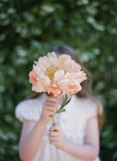 Close up of girl holding bouquet of flowers