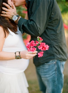 Man kissing pregnant wife outdoors