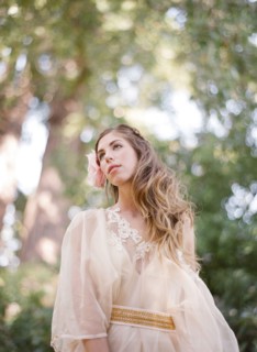 Bride walking under trees