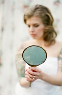 Bride admiring herself in mirror