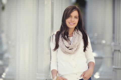 Smiling woman leaning on columns