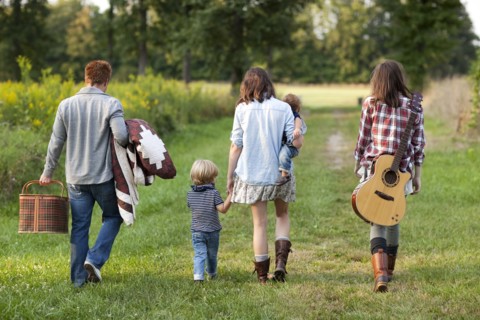 Family walking in rural field