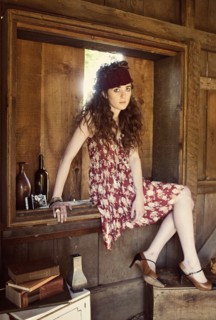 Woman sitting in barn window