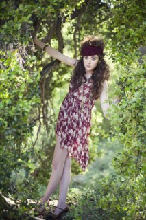 Woman in vintage dress climbing tree