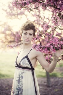 Woman walking under flowering trees in garden
