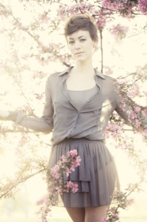 Woman standing in flowering trees