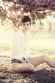 Woman in lingerie under flowering trees