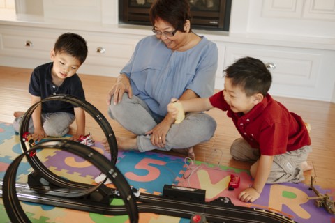 Asian grandmother playing with grandsons