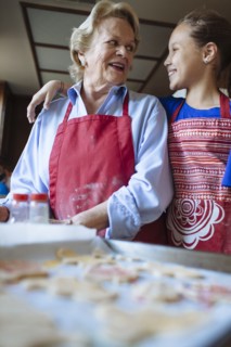 Grandmother and granddaughter baking cookies in kitchen