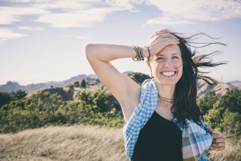 Caucasian woman laughing in rural field