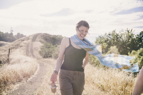 Caucasian woman walking on rural dirt road