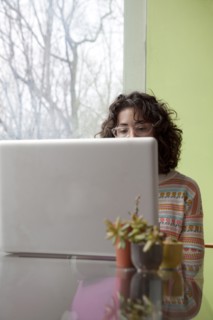 Caucasian businesswoman using laptop at desk