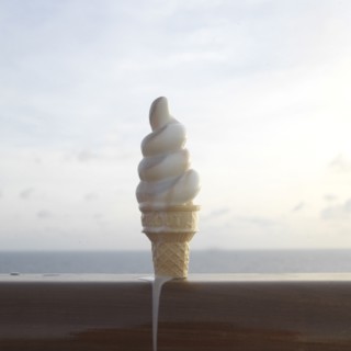 Close up of melting ice cream cone on banister